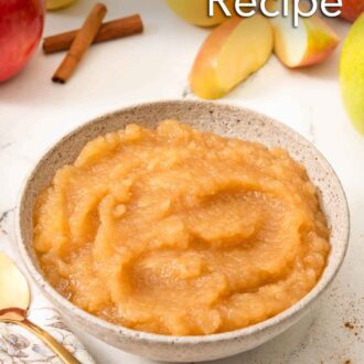Pinterest graphic of a bowl of applesauce with apples and cinnamon in the background.
