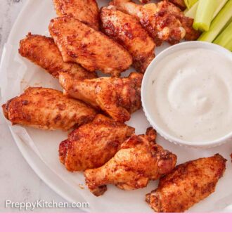 Pinterest graphic of an overhead view of a platter of chicken wings, celery, and a small bowl of dip.