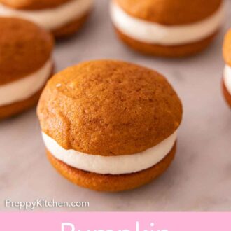Pinterest graphic of a pumpkin whoopie pie in focus with multiple more in the background.