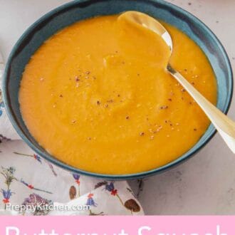 Pinterest graphic of a teal bowl of butternut squash soup with a spoon tucked in.