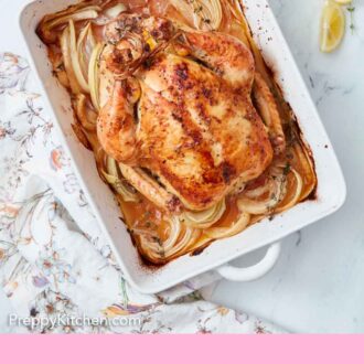 Pinterest graphic of an overhead view of a roasted chicken in a white baking dish with onions underneath.