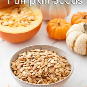 Pinterest graphic of a bowl of roasted pumpkin seeds with a cut pumpkin and mini whole pumpkins in the background.