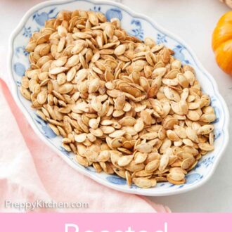 Pinterest graphic of an oval plate of roasted pumpkin seeds with mini pumpkins off to the side.
