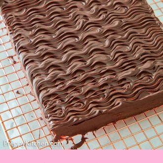 Pinterest graphic of an overhead view of an uncut sheet of rainbow cookies with chocolate on top.