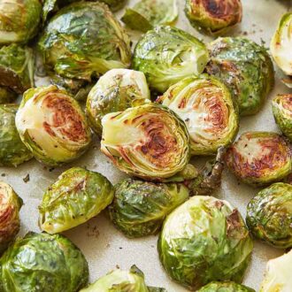 Roasted Brussels sprouts on a sheet pan, showing the browned cut-side.