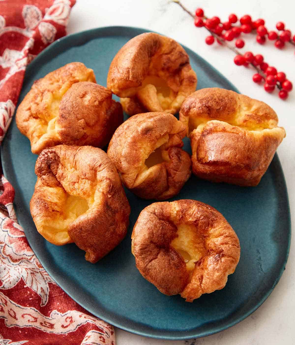 Overhead view of an oval platter with six Yorkshire puddings.