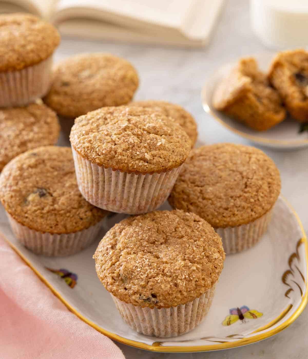 An oval serving platter with multiple bran muffins.