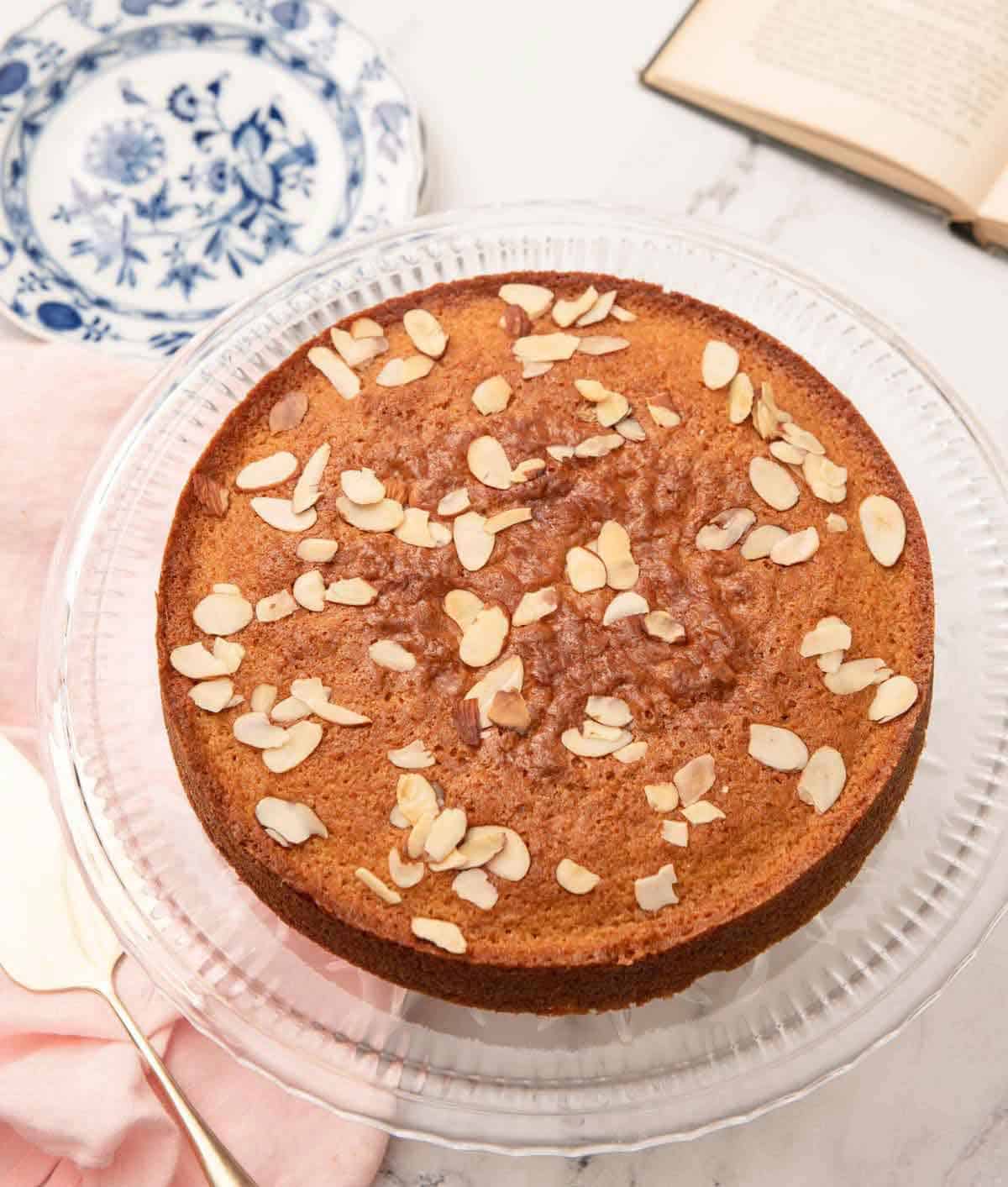 Overhead view of a honey cake with sliced almonds on top.