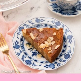 Pinterest graphic of a plate with a slice of honey cake with a mug of coffee in the back.