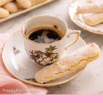 Pinterest graphic of a ladyfinger beside a cup of coffee with additional ladyfingers in the back.