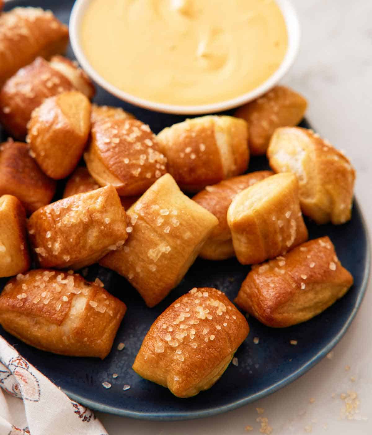 A platte of pretzel bites with a small bowl of dip.