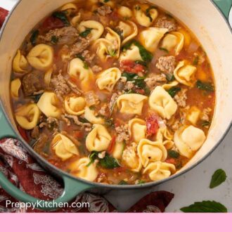 Pinterest graphic of a large green dutch oven with tortellini soup.