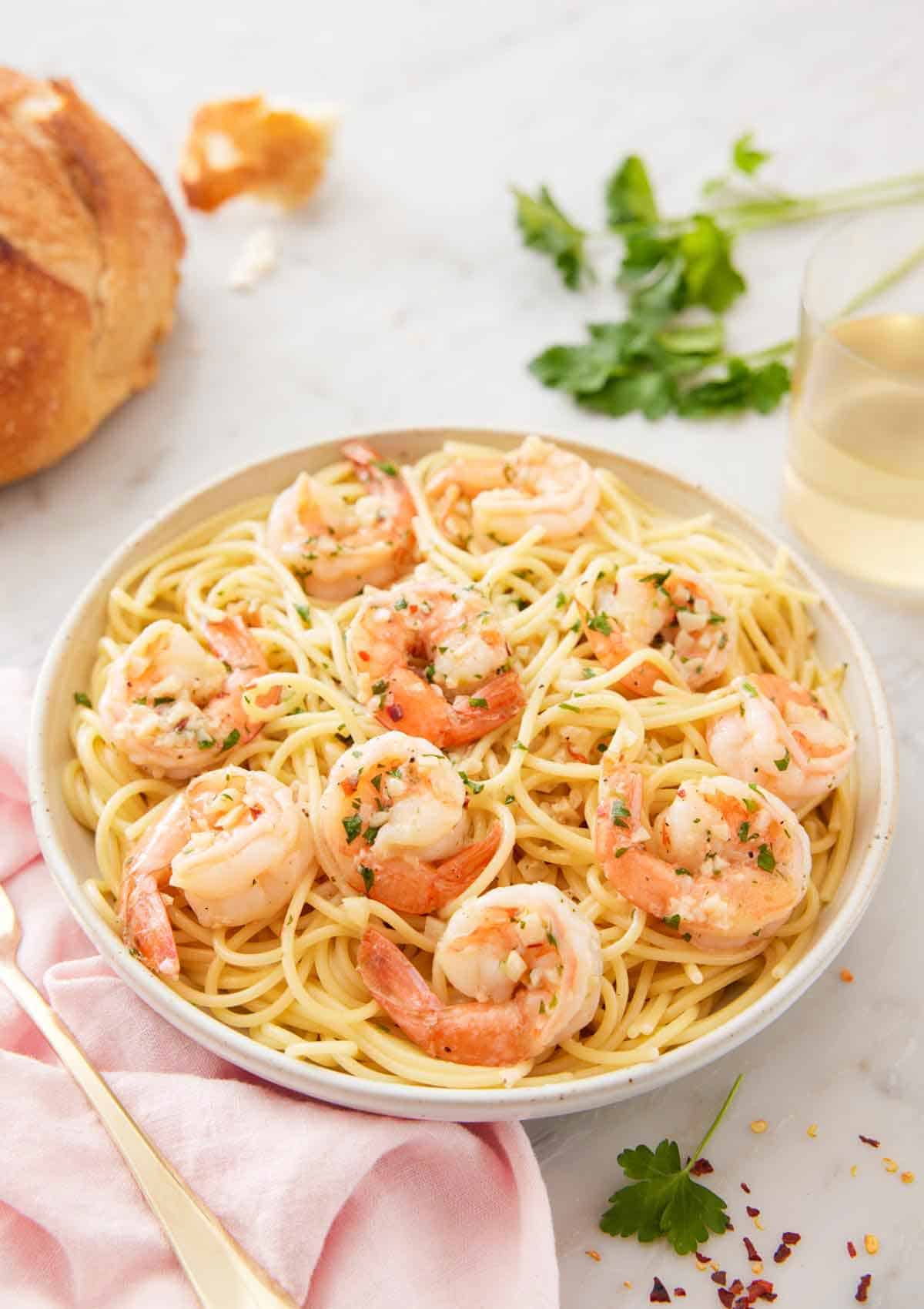 A bowl of pasta topped with shrimp scampi.