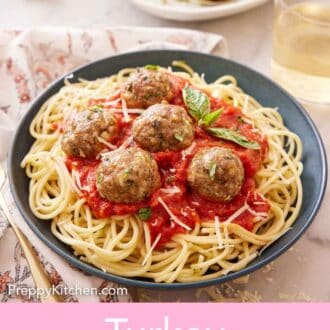 Pinterest graphic of a plate of noodles with sauce topped with turkey meatballs and basil.