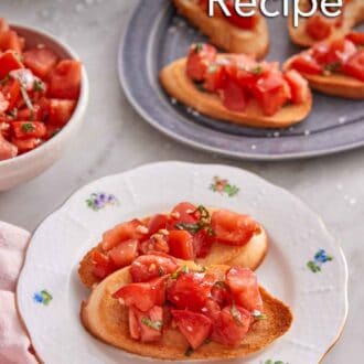 Pinterest graphic of a plate with two pieces of bruschetta with a platter with more in the background.