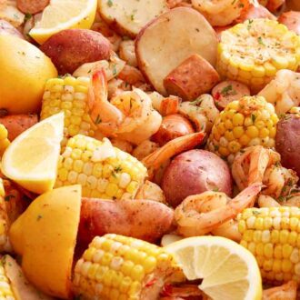Close up view of shrimp boil topped with chopped parsley.
