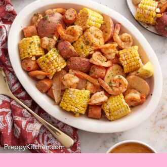 Pinterest graphic of a platter of shrimp boil with some plated servings off to the side.