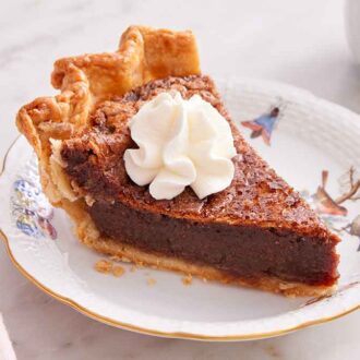 A slice of chocolate chess pie with a dollop of whipped cream on top.