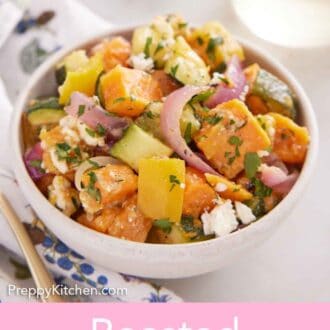 Pinterest graphic of a bowl of roasted vegetable salad topped with chopped parsley and a glass in the background.