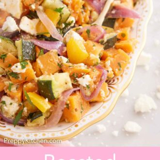 Pinterest graphic of a spoon tucked into a platter of roasted vegetable salad with crumbled feta scattered around.