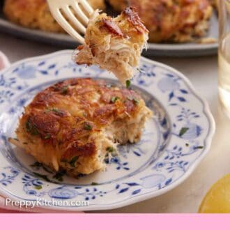 Pinterest graphic of a bite of crab cake lifted from the piece on the plate.