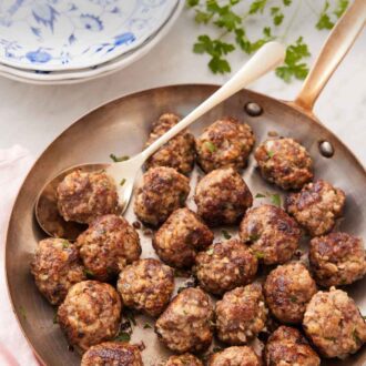 Pinterest graphic of a skillet of meatballs with a spoon underneath one.