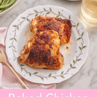 Pinterest graphic of a plate with two baked chicken thighs beside a glass of wine.