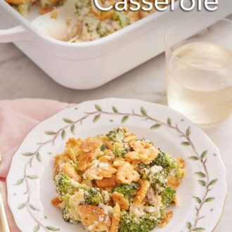 Pinterest graphic of a plate with a serving of broccoli casserole with a glass of wine and baking dish in the background.