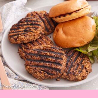 Pinterest graphic of a plate with multiple veggie burger patties with two buns. Sliced tomatoes and fries in the background.