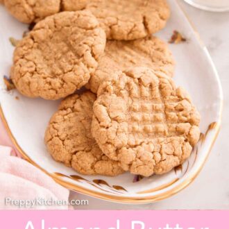 Pinterest graphic of a platter with almond butter cookies with a glass of milk on the side.