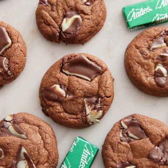 Overhead view of Andes Mint Cookies in a single layer with wrapped chocolates around them.
