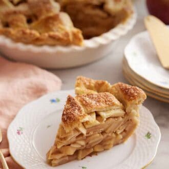 Pinterest graphic of a slice of apple pie on a plate in front of the rest of the pie.