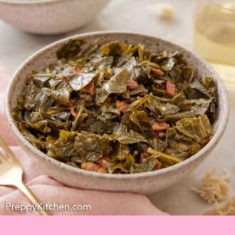 Pinterest graphic of a bowl of collard greens in focus with a second bowl, glass of wine, and some torn bread in the back.