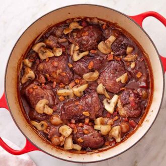 Overhead view of a pot of coq au vin.