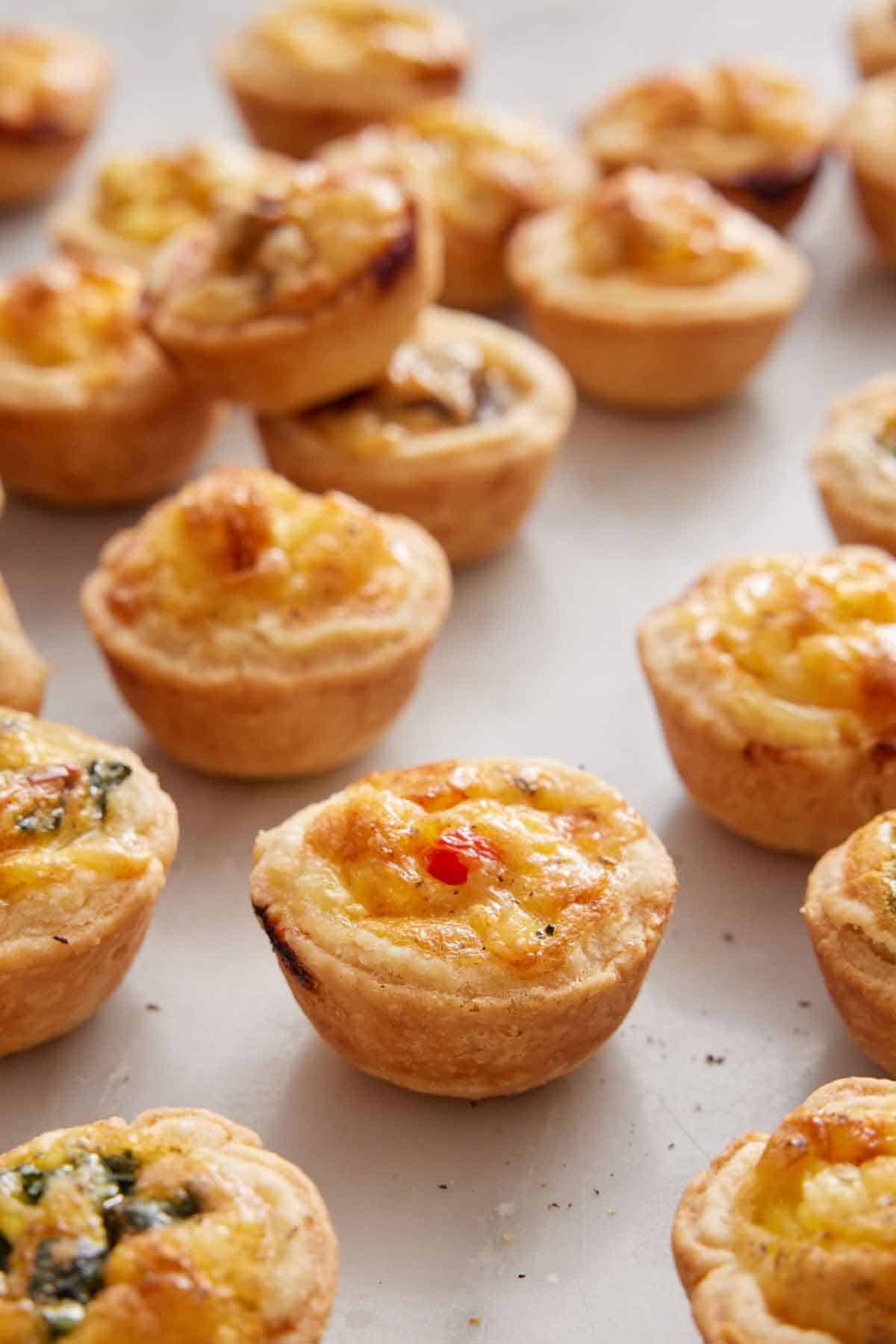 Mulitple mini quiches with one in focus.