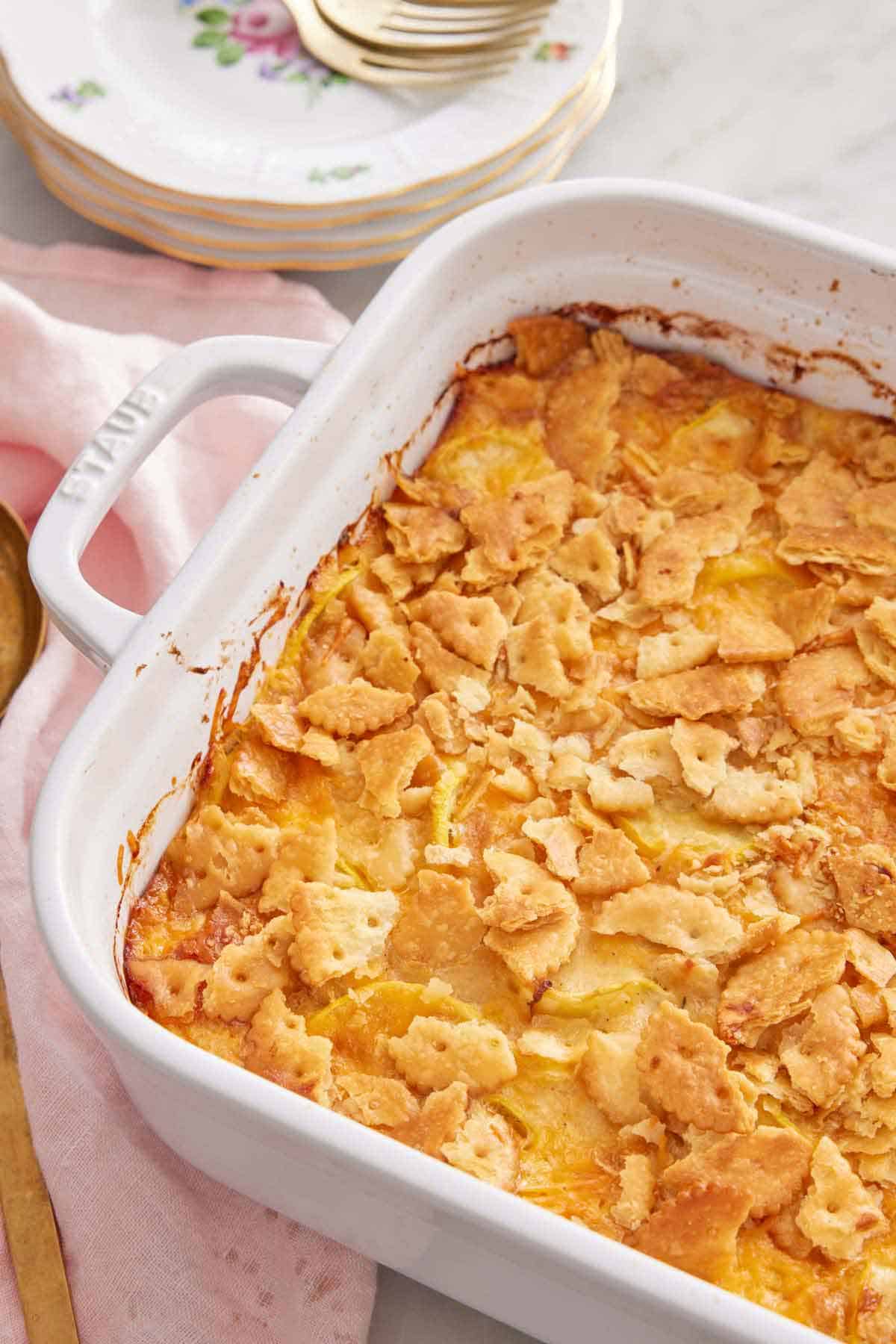 Overhead view of a white baking dish containing squash casserole.