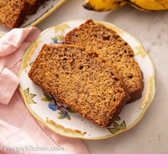 Pinterest graphic of a plate with two slices of banana bread with a platter in the background with the rest of the sliced loaf. Bananas off to the side.