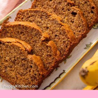 Pinterest graphic of sliced banana bread on a platter.