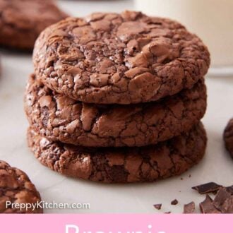 Pinterest graphic of a stack of three brownie cookies with a cup of milk in the background and more cookies and chopped chocolate scattered around.