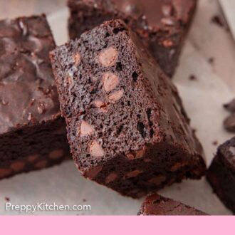 Pinterest graphic of a brownie leaning on another, showing the interior cut-side.