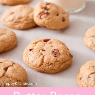 Pinterest graphic of butter pecan cookies scattered on a marble counter with a glass of milk.