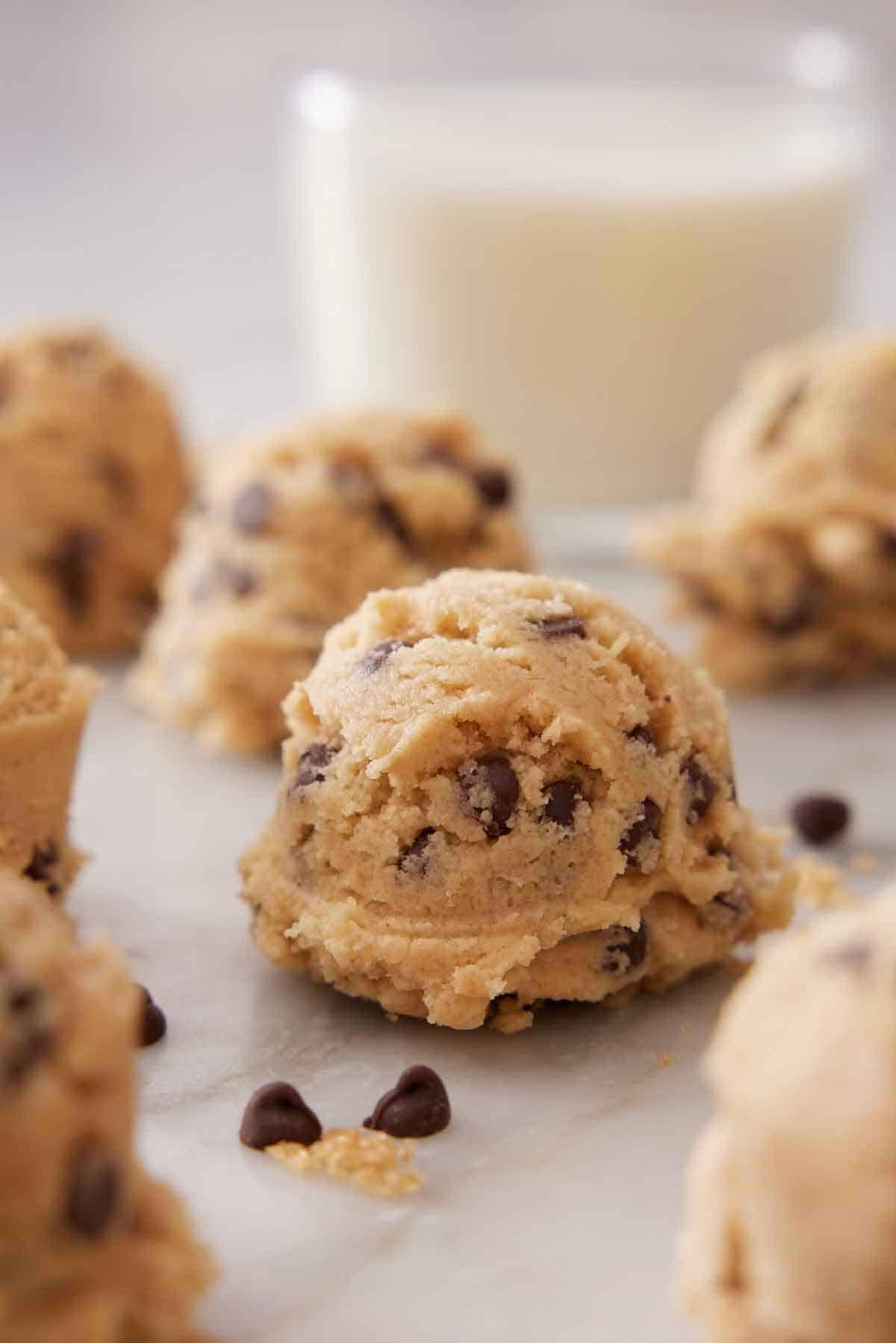 Scoops of edible cookie dough on a marble surface.