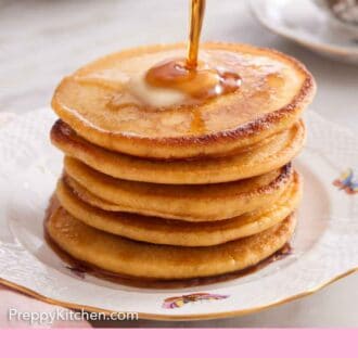 Pinterest graphic of a stack of Johnny cakes with a knob of butter on top and maple syrup poured over top.