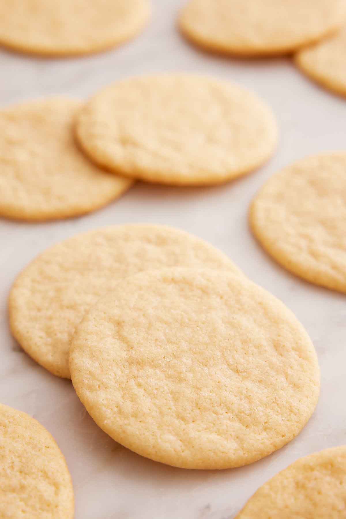 A tea cake stacked over another with more tea cakes in the background.