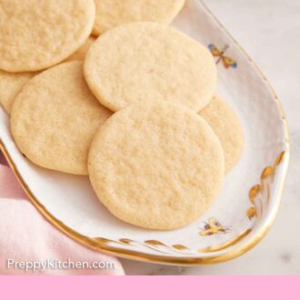 Pinterest graphic of a platter of tea cakes with some plates in the background.