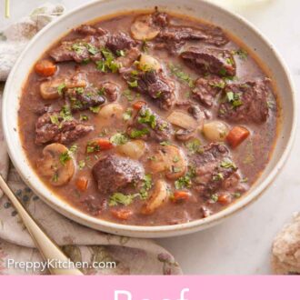 Pinterest graphic of a bowl of beef bourguignon topped with chopped parsley. Wine and parsley in the background.