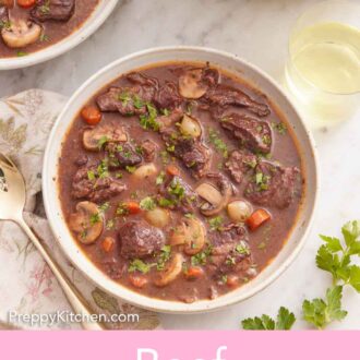 Pinterest graphic of an overhead view of a bowl of beef bourguignon with a glass of wine, pot of more beef bourguignon, and a second bowl off to the side.