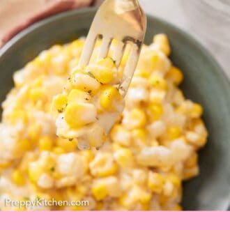 Pinterest graphic of a fork lifting up a bite of creamed corn from a plate.