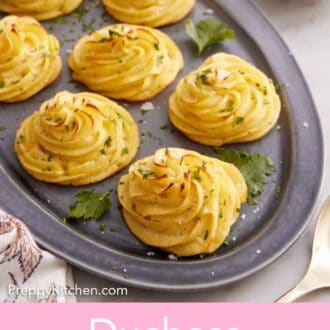 Pinterest graphic of a platter with multiple servings of duchess potatoes topped with parsley and flaky salt.