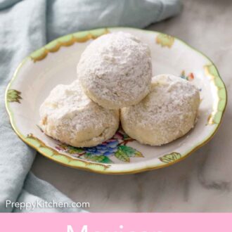 Pinterest graphic of a plate with three Mexican wedding cookies.